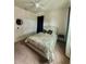 This bedroom features a ceiling fan, a double closet, and natural light from the window at 14117 Larkspur Lake Dr, Winter Garden, FL 34787