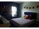Charming bedroom with blue walls, Star Wars decorations, and a plush teddy bear on the comfortable bed at 14117 Larkspur Lake Dr, Winter Garden, FL 34787
