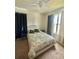This bedroom features a ceiling fan, a double closet, and natural light from the window at 14117 Larkspur Lake Dr, Winter Garden, FL 34787