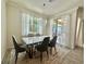 Bright dining room with modern chandelier, a white table with seating for six, and large windows at 14117 Larkspur Lake Dr, Winter Garden, FL 34787