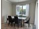 Inviting dining room with a modern chandelier, seating for six and natural light from a large window at 14117 Larkspur Lake Dr, Winter Garden, FL 34787