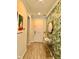 Inviting entryway features stylish wallpaper, decor table with mirror, and tile flooring at 14117 Larkspur Lake Dr, Winter Garden, FL 34787
