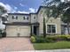 Charming two-story home featuring a three-car garage, landscaped yard, and classic architectural details at 14117 Larkspur Lake Dr, Winter Garden, FL 34787