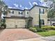 Charming two-story home featuring a three-car garage, landscaped yard, and classic architectural details at 14117 Larkspur Lake Dr, Winter Garden, FL 34787