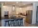 Modern kitchen with stainless steel appliances, large center island with seating, and ample counter space at 14117 Larkspur Lake Dr, Winter Garden, FL 34787