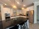 Elegant kitchen with white cabinets, stainless steel appliances, and a large island with bar stools at 14117 Larkspur Lake Dr, Winter Garden, FL 34787
