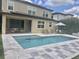 Backyard with swimming pool, outdoor lounge chairs, and privacy landscaping at 14117 Larkspur Lake Dr, Winter Garden, FL 34787