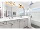 Bathroom featuring dual sinks, a spacious glass shower, and a large well lit mirror at 14215 Lakeview Park Rd, Winter Garden, FL 34787