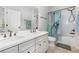 Elegant bathroom with a dual sink vanity, marble countertops, and shower with glass doors at 14215 Lakeview Park Rd, Winter Garden, FL 34787