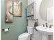 Stylish half bathroom showcases a pedestal sink, updated fixtures, and neutral decor at 14215 Lakeview Park Rd, Winter Garden, FL 34787