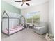 Comfortable bedroom with a gray chair, large window, and cute decor at 14215 Lakeview Park Rd, Winter Garden, FL 34787