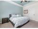 Comfortable bedroom featuring a king-sized bed, ceiling fan, and a tranquil color palette at 14215 Lakeview Park Rd, Winter Garden, FL 34787