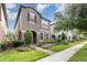 Charming two-story home featuring a landscaped yard, complemented by a brick pathway and well-maintained lawn at 14215 Lakeview Park Rd, Winter Garden, FL 34787