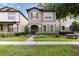 Charming two-story home with a landscaped front yard, inviting entrance, and neutral-colored exterior at 14215 Lakeview Park Rd, Winter Garden, FL 34787