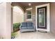 Inviting front porch features a comfortable seating area, a stylish front door with a glass panel, and a welcoming atmosphere at 14215 Lakeview Park Rd, Winter Garden, FL 34787