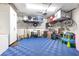Garage featuring epoxy flooring, storage shelving, organized storage, and a modern garage door opener at 14215 Lakeview Park Rd, Winter Garden, FL 34787