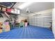 Garage featuring epoxy flooring, storage shelving, organized storage, and a modern garage door at 14215 Lakeview Park Rd, Winter Garden, FL 34787