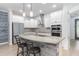 Modern kitchen features white cabinets, granite countertops, stainless steel appliances, and an island with seating at 14215 Lakeview Park Rd, Winter Garden, FL 34787