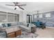 Open-concept living area with a sectional sofa, a dining table, modern lighting, and a decorative accent wall at 14215 Lakeview Park Rd, Winter Garden, FL 34787