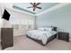 Tranquil main bedroom offers a comfortable bed, soft lighting, and an en suite bathroom at 14215 Lakeview Park Rd, Winter Garden, FL 34787