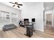 Inviting home office features a sleek glass desk, plush seating, and plenty of natural light at 14215 Lakeview Park Rd, Winter Garden, FL 34787