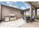 Relaxing covered patio with comfortable seating and a summer kitchen with a built-in grill at 14215 Lakeview Park Rd, Winter Garden, FL 34787