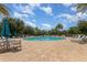 Community pool surrounded by lush landscaping and comfortable seating for relaxing afternoons at 14215 Lakeview Park Rd, Winter Garden, FL 34787