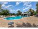 Relaxing community pool with chairs and tables offers resort-style living on a sunny day at 14215 Lakeview Park Rd, Winter Garden, FL 34787