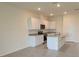 The kitchen has white cabinets, granite counters, stainless appliances, and an eat-in island at 1518 Isleta Loop, Kissimmee, FL 34741