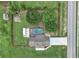 Aerial view of the property showcasing a private pool, large lot, and proximity to the road at 15650 Catherine Cir, Groveland, FL 34736