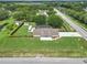 Expansive aerial view of a home showcasing a large lot, screened pool, RV, and mature trees at 15650 Catherine Cir, Groveland, FL 34736