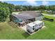 Aerial view of the property highlighting the screened pool, RV parking, and lush green lawn at 15650 Catherine Cir, Groveland, FL 34736