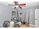 Bedroom with a ceiling fan, window, and a collection of fishing poles against the wall at 15650 Catherine Cir, Groveland, FL 34736