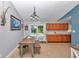 Dining area with a rustic table, access to the pool, and an adjacent kitchen at 15650 Catherine Cir, Groveland, FL 34736