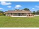 Inviting home with dormer windows, shutters, landscaped flower beds, and a cozy front porch at 15650 Catherine Cir, Groveland, FL 34736