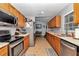 Spacious kitchen featuring stainless steel appliances, tile flooring and light wood cabinetry at 15650 Catherine Cir, Groveland, FL 34736