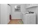 Bright laundry room with white washer and dryer, ample storage and natural light at 15650 Catherine Cir, Groveland, FL 34736