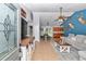 Open-concept living space with tile floors, high ceilings, and a modern color palette at 15650 Catherine Cir, Groveland, FL 34736
