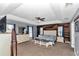 Main bedroom features a statement accent wall, ceiling fan and neutral decor at 15650 Catherine Cir, Groveland, FL 34736