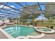 Inviting screened-in pool with a spa, basketball hoop, and plenty of room to relax in the Florida sun at 15650 Catherine Cir, Groveland, FL 34736