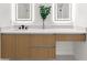 Bathroom featuring a modern vanity with wood cabinets, stone countertop, and dual illuminated mirrors at 1700 Shandwick Ct, Longwood, FL 32779