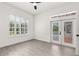 Bright bedroom features lots of light from a large window and french doors leading to the pool area at 1700 Shandwick Ct, Longwood, FL 32779