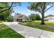 A long, curved driveway leads to this lovely home with verdant lawn and side-entry garage at 1700 Shandwick Ct, Longwood, FL 32779