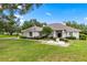 Well-maintained home with a manicured lawn, mature trees, and an inviting entrance at 1700 Shandwick Ct, Longwood, FL 32779