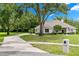 Stunning single-story home with a lush front yard, mature trees, and long driveway at 1700 Shandwick Ct, Longwood, FL 32779