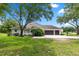 Side view of lovely home with lush lawn, landscaping, and a convenient two-car garage at 1700 Shandwick Ct, Longwood, FL 32779