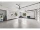 Spacious three car garage with newly epoxied floors and ample storage and natural light at 1700 Shandwick Ct, Longwood, FL 32779