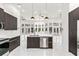 Open kitchen island overlooks bright living room with pool view from wall of windows at 1700 Shandwick Ct, Longwood, FL 32779