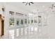 Spacious living room featuring white tile floors, many windows, and access to a pool at 1700 Shandwick Ct, Longwood, FL 32779