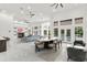 Open-concept living area boasts modern furnishings, fireplace, and access to the outdoor pool area at 1700 Shandwick Ct, Longwood, FL 32779